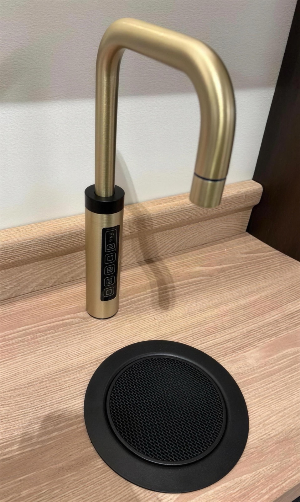 Brushed gold RoyalFlow drinking water tap with a black drip tray, installed on a timber worktop